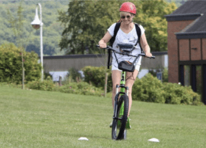 participant on an electric scooter during the 1001 milestones