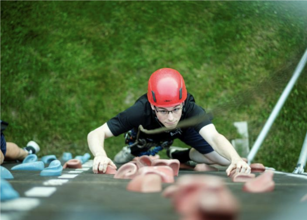 participant climbing a climbing wall at the Secret Agent School