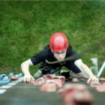 participant climbing a climbing wall at the Secret Agent School