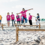 participants hurdling on the beach for Robinson's Quest