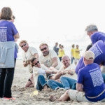 participants in the Beach & Water Olympics tug-of-war event