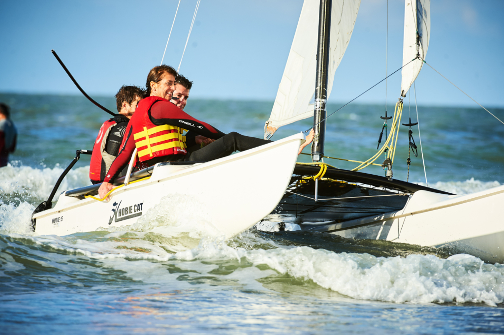 participants sailing catamarans during the Beach & Water Olympics