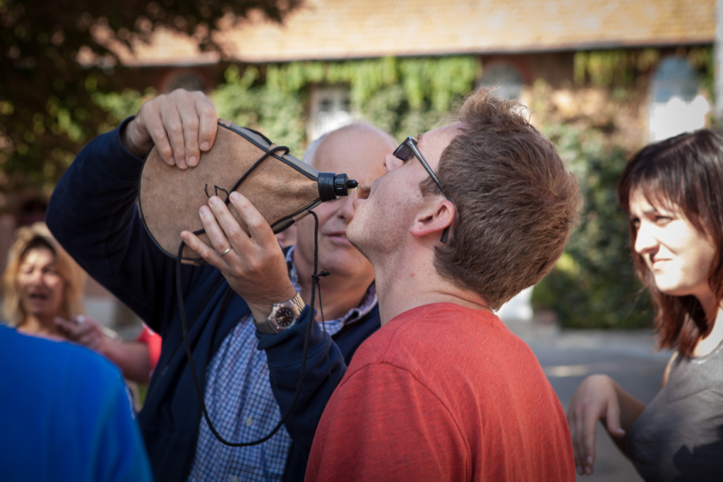 participant tasting a beverage during Enquête au Château