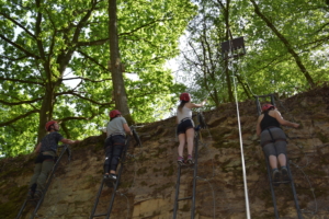 participants climbing a natural wall during the Lost