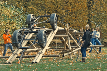 team towing a vehicle on a bridge built during the Lumberjack