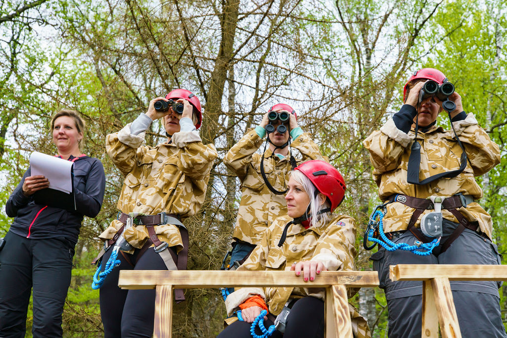 team observing with binoculars during the Step out of your comfort zone