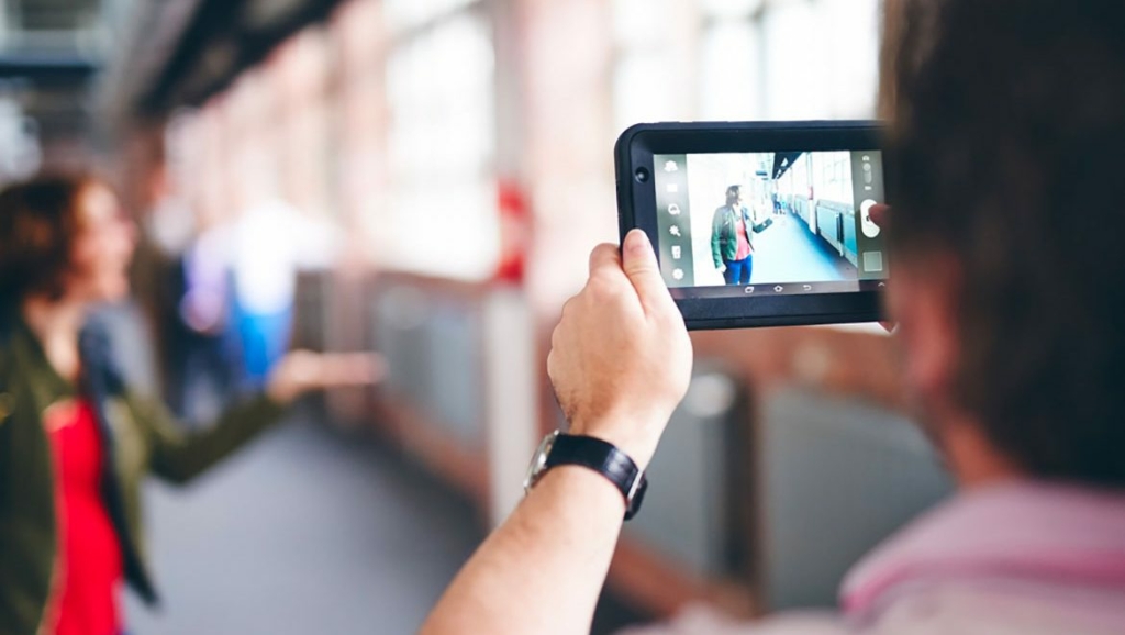 tablet with film during city play