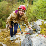 smiling participant who follows the rope course during the Step out of your comfort zone